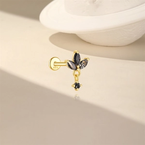 Macro shot of S925 sterling silver ear stud with black stones and a small charm