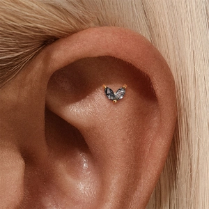 Macro view of a s925 silver ear stud with marquise-cut black rutilated quartz gemstone