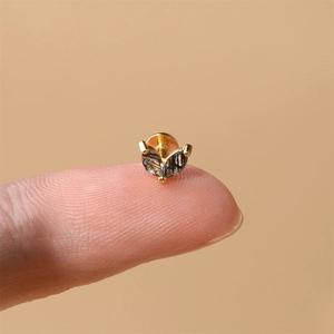 Detailed close-up of s925 gold-plated stud earring with black rutilated quartz gem