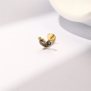 Macro shot of gold S925 silver stud with marquise black rutilated quartz in leaf design