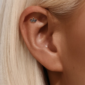 Macro shot of s925 silver ear stud with marquise black gemstones in crown cluster design