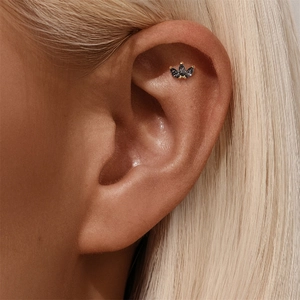 Macro view of a gold s925 silver stud with marquise black crystal crown arrangement