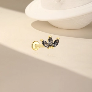 Detailed macro view of S925 silver gold crown stud earring with black marquise gemstones