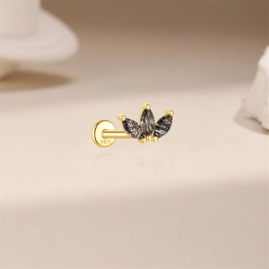 Macro view of S925 silver earring featuring black stones in a crown leaf shape