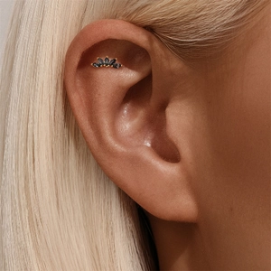 Detailed view of s925 silver helix stud with black marquise gems and gold setting