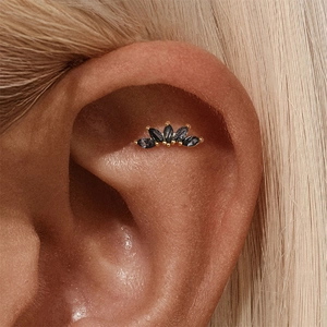 Macro shot of s925 silver crown flower piercing stud with black rutilated quartz