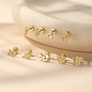 Close-up of gold S925 sterling silver ear stud set with clear material engraving