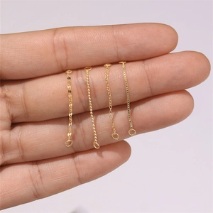 Detail of four gold jewelry chain styles including bead, flat, link, and box chain types