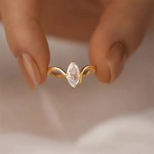 Close-up of marquise cut zircon ring with minimalist double curved 18K gold plated band