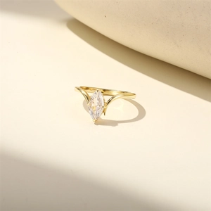 Macro view of marquise-cut marquise zircon ring with gold band on minimalist background