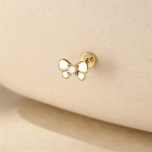 Macro shot of S925 sterling silver golden butterfly stud earring with a clear zircon