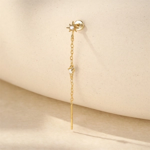 Detail of s925 gold-plated sterling silver long tassel earring with star and diamond accent