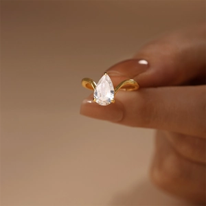 Macro shot of s925 silver pear cut zircon ring with elegant V-shaped gold plated band