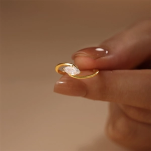 Detail of s925 silver marquise-cut zircon ring with gold finish and wrap-around design