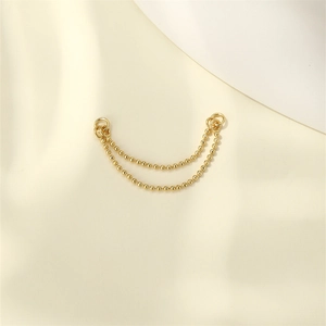 Close-up of golden double-layer beaded chains with connecting rings for DIY jewelry