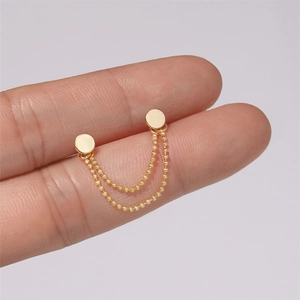 Macro detail of gold S925 silver double stud earrings with delicate ball chain connection