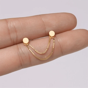 Macro shot of double stud gold earrings with parallel box chains connecting two flat discs