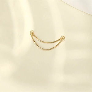 Detail of double-layer gold box chains on satin fabric for earrings accessories