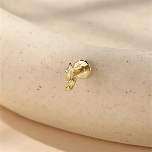 Close-up of S925 sterling silver leaf stud earring with detailed texture and gold finish