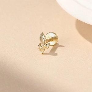 Close-up of golden leaf cartilage stud with S925 hallmark on a neutral background