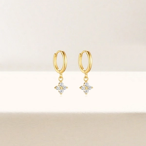 Detail of 18K gold S925 silver earrings with sparkling zircon four-petal flower charms