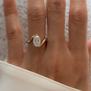 Detail of s925 silver bypass ring with a large cushion-cut zircon stone on a hand
