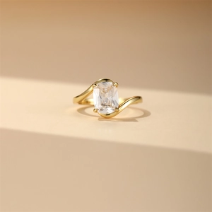Macro shot of s925 silver gold-plated bypass ring with large rectangular zircon