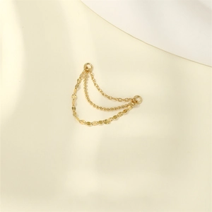 Detailed macro of gold-plated triple layer chain accessory with flat lip and bead link