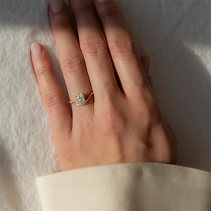 Detailed view of an oval-cut zircon stone on a V-shaped S925 silver engagement ring