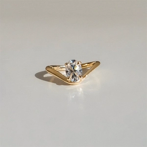 Detailed close-up of 18K gold hallmark on V-shaped ring with large oval-cut gemstone