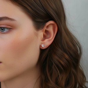 Primer plano de un pendiente minimalista de moissanita en la oreja de una mujer real