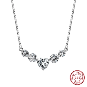 Macro detail of 925 sterling silver smile necklace featuring heart-shaped moissanite pendant