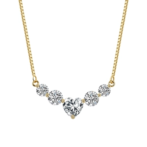Detail of 925 silver smile necklace with shiny moissanite heart pendant in gold finish