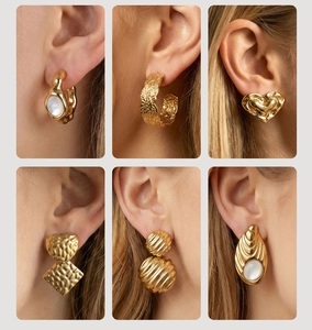 Detail shots of French vintage gold earrings with mother of pearl and embossed designs