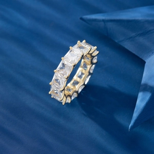 Macro shot of an emerald cut cubic zirconia eternity ring in gold plating