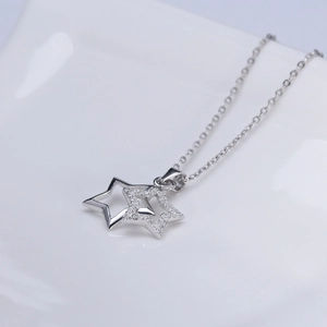 Detail of S925 sterling silver double star pendant with shimmering cubic zirconia crystals