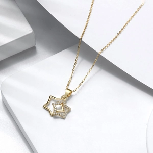 Detailed macro view of gold plated S925 silver double star pendant with zircon stones