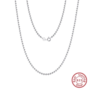 Macro detail of 925 sterling silver ball chain necklace with secure spring ring clasp