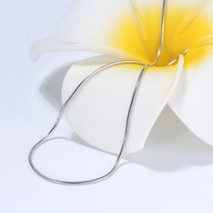 Authentic s925 sterling silver 1mm snake chain necklace displayed on a tropical plumeria flower