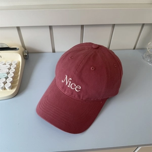 Deep red cotton baseball cap with white Nice embroidery in a retro minimalist aesthetic