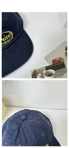 Macro detail of navy blue washed cotton baseball cap with yellow embroidered rise patch
