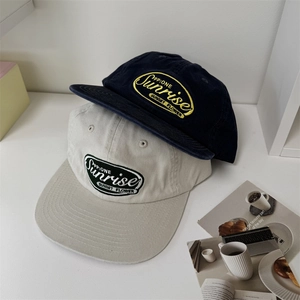 Classic navy blue and beige cotton baseball caps with vintage sunrise embroidery patches