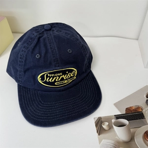 Vintage navy blue cotton baseball cap with yellow Sunrise embroidery in street style