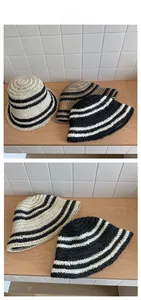 Detailed view of woven straw sun hats featuring classic contrast stripe texture and patterns