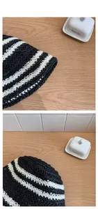 Detail shot of the tight black and white woven texture on a floppy striped sun hat
