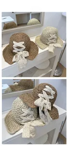 Detail of straw sun hat featuring elegant lace ribbons and woven texture for summer