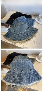 Detail of distressed denim bucket hat with frayed edges and star metal rivets