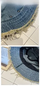 Detail of light blue denim bucket hat with distressed edges and adjustable strap