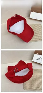 Detail of red cotton baseball cap featuring adjustable metal slider and inner structure