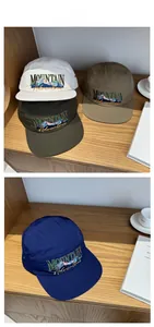 Detail showing five-panel quick-dry baseball caps in four colors with mountain embroidery